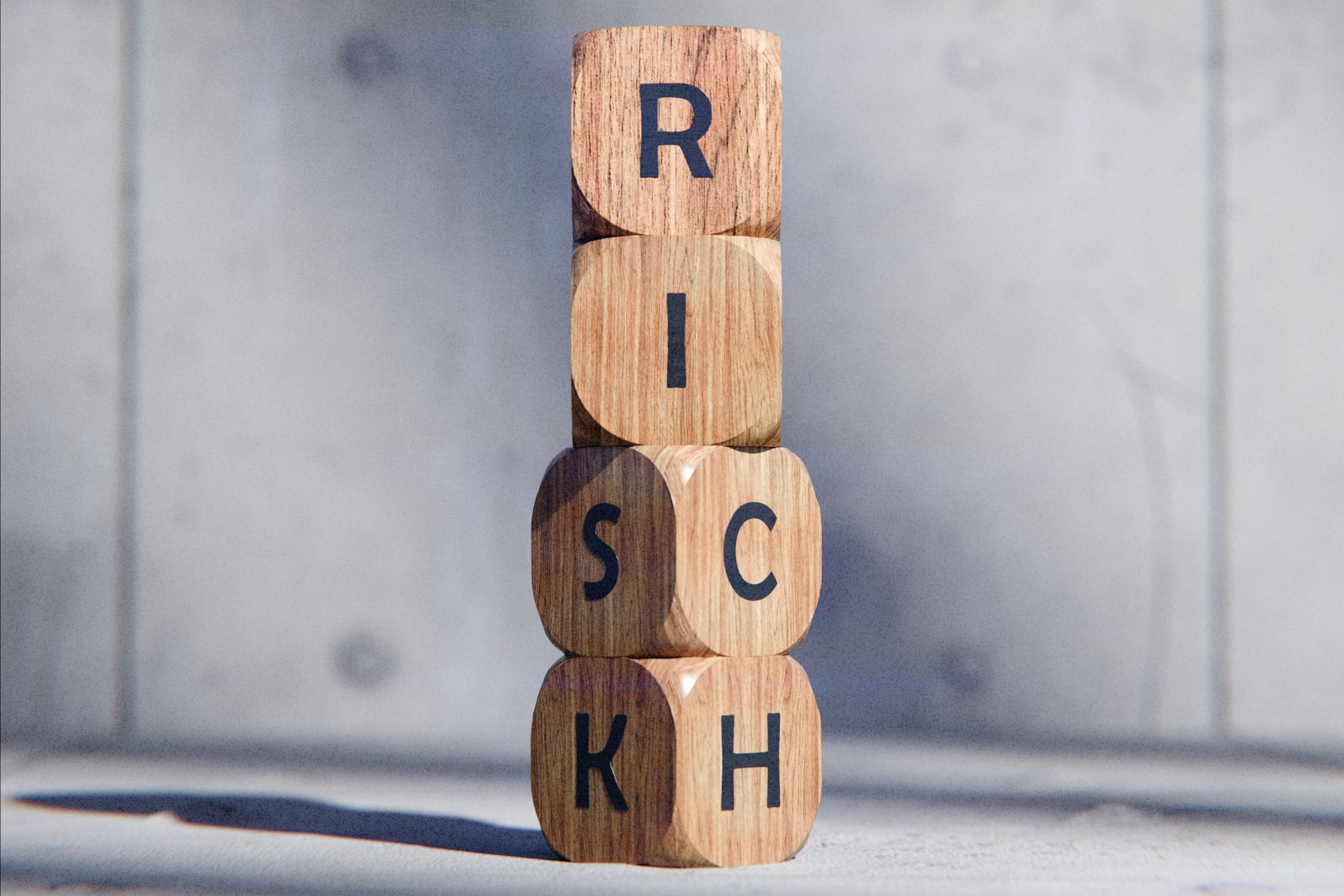 Stacked wooden blocks spelling 'RISK' concept, symbolizing caution and strategy.
